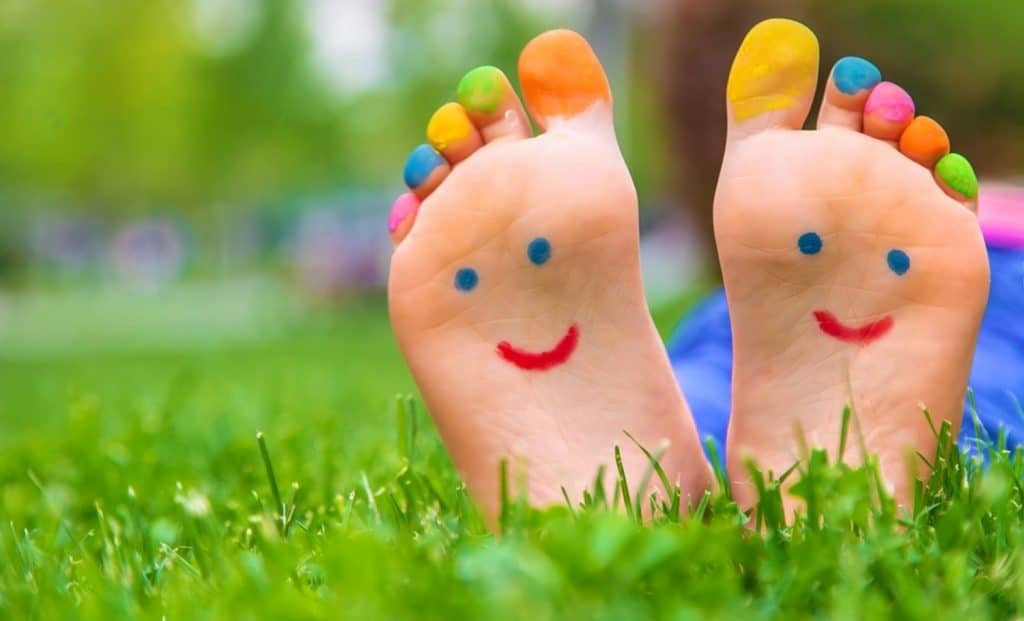 deux pieds avec de la peinture et un sourire dessus