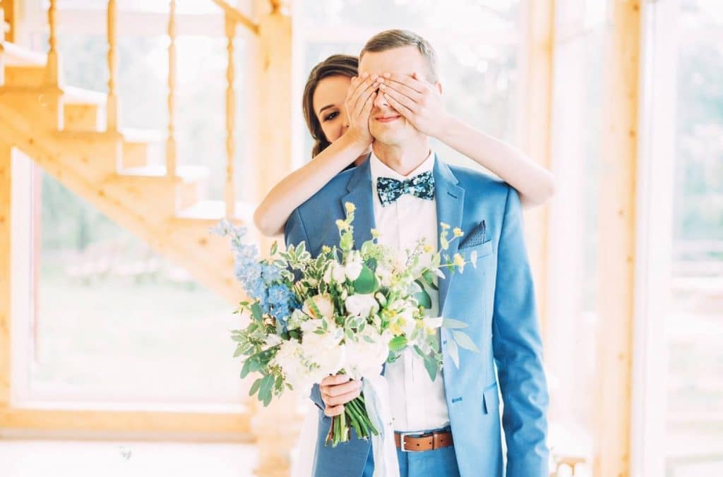 un marié qui attend sa femme le jour du mariage et sa femme lui cache les yeux